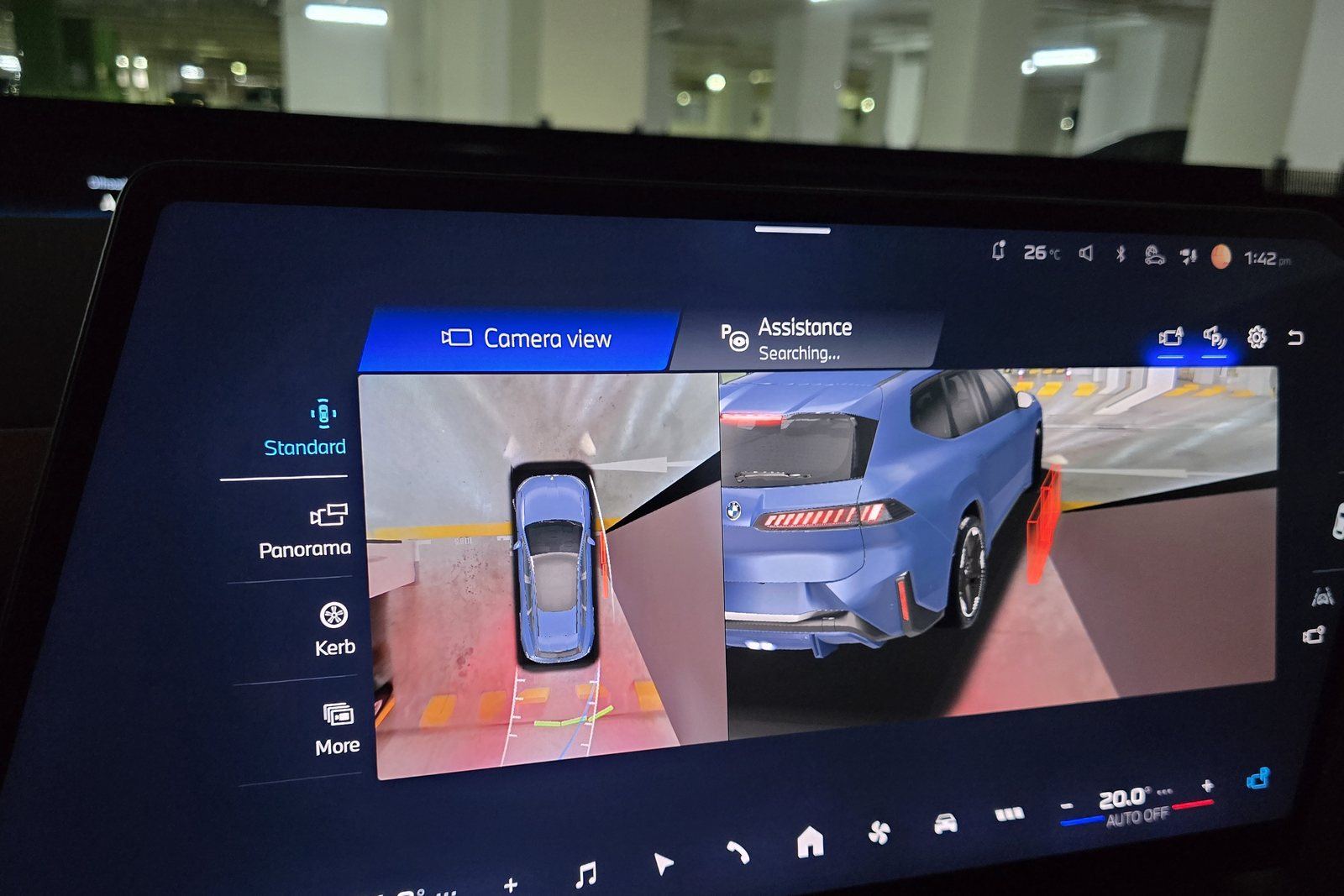 BMW iX3 17.9-inch central display in its free-cut shape, showing the parking camera view