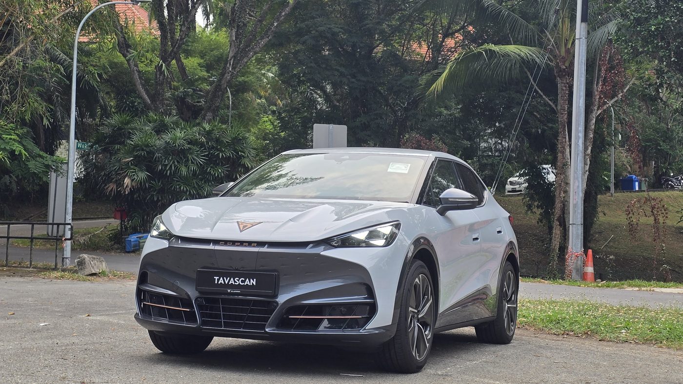 Cupra Tavascan Endurance in White Silver, front three-quarter view in a tree-lined carpark in Singapore