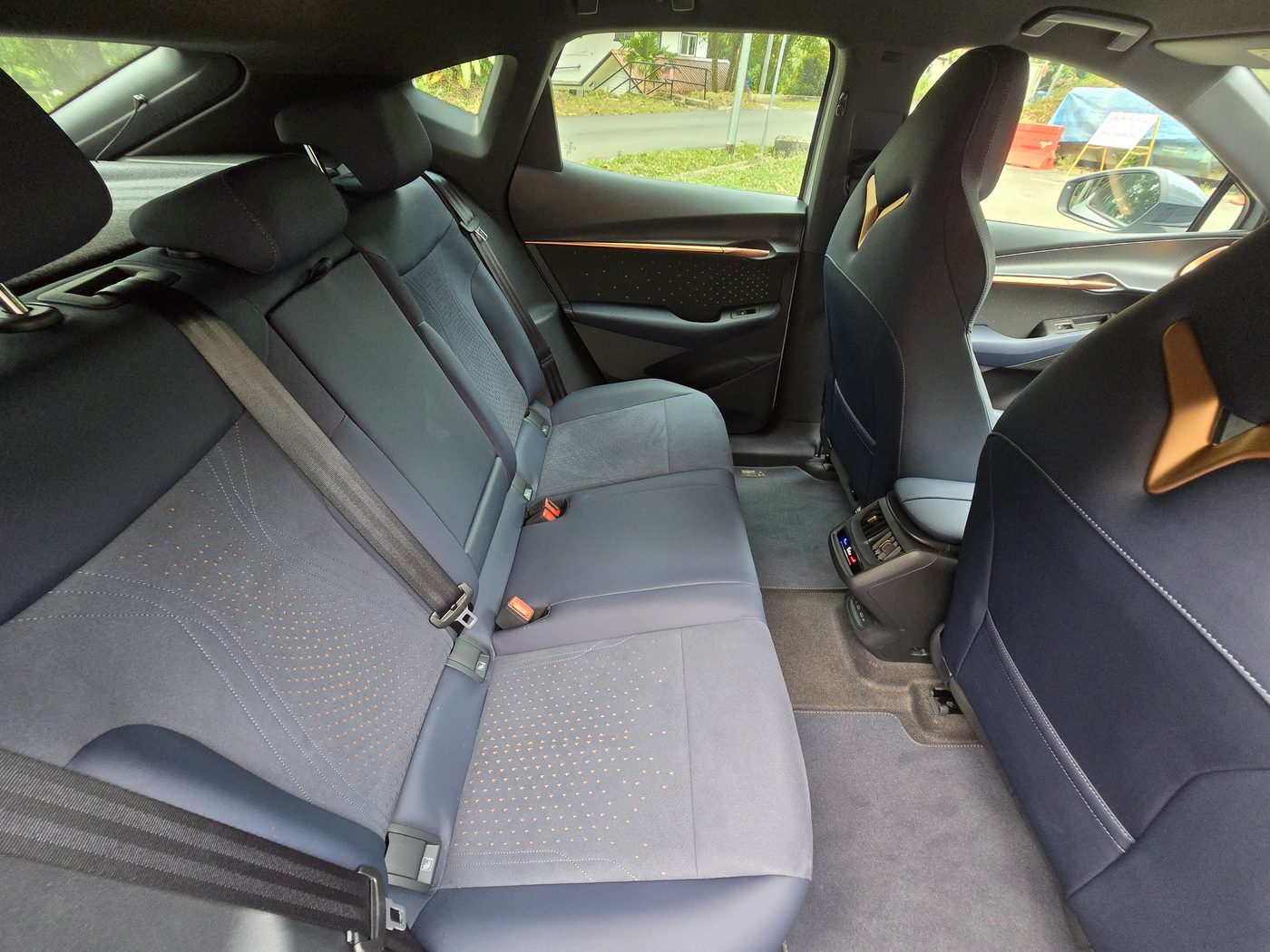 Cupra Tavascan rear bench in dark grey fabric with the centre armrest
