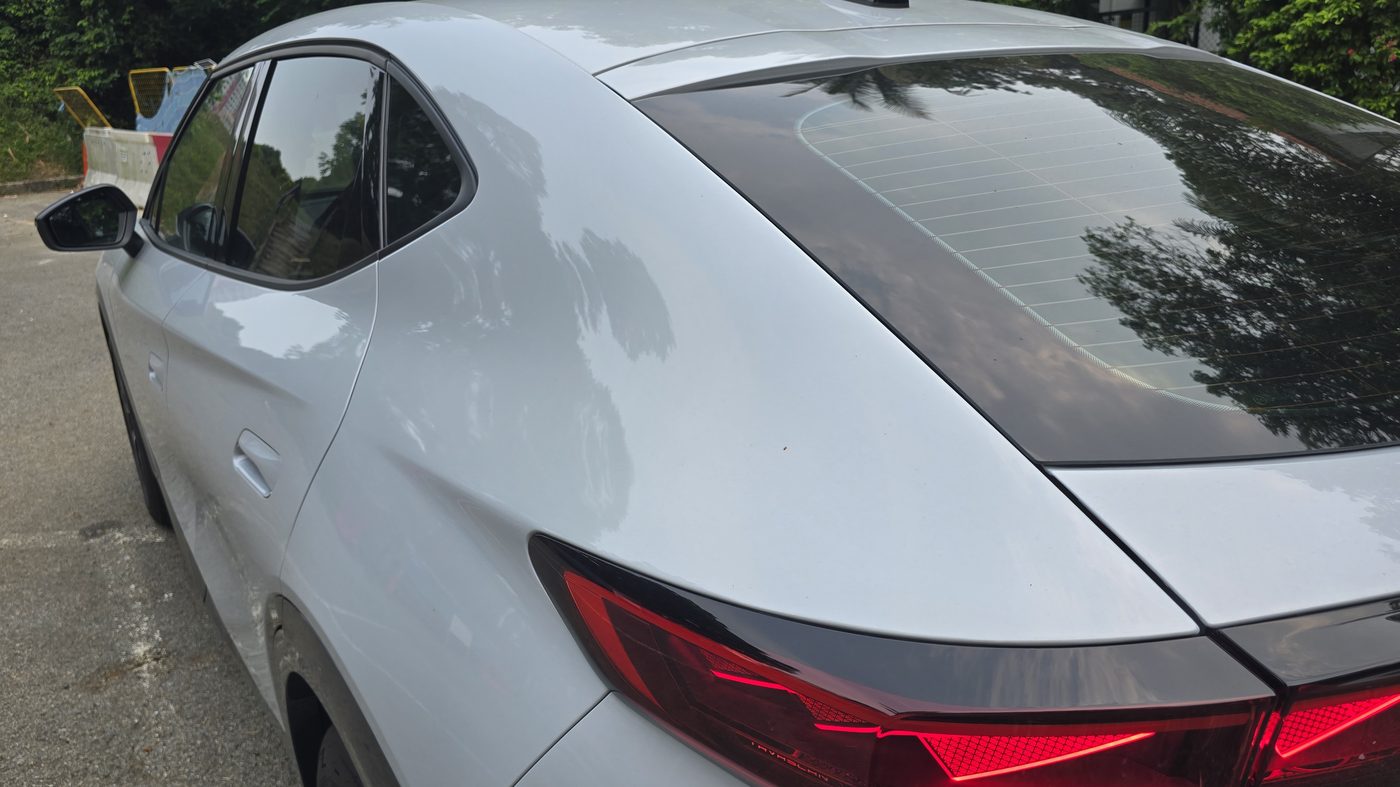 Cupra Tavascan rear light cluster with the triangular signature lit red