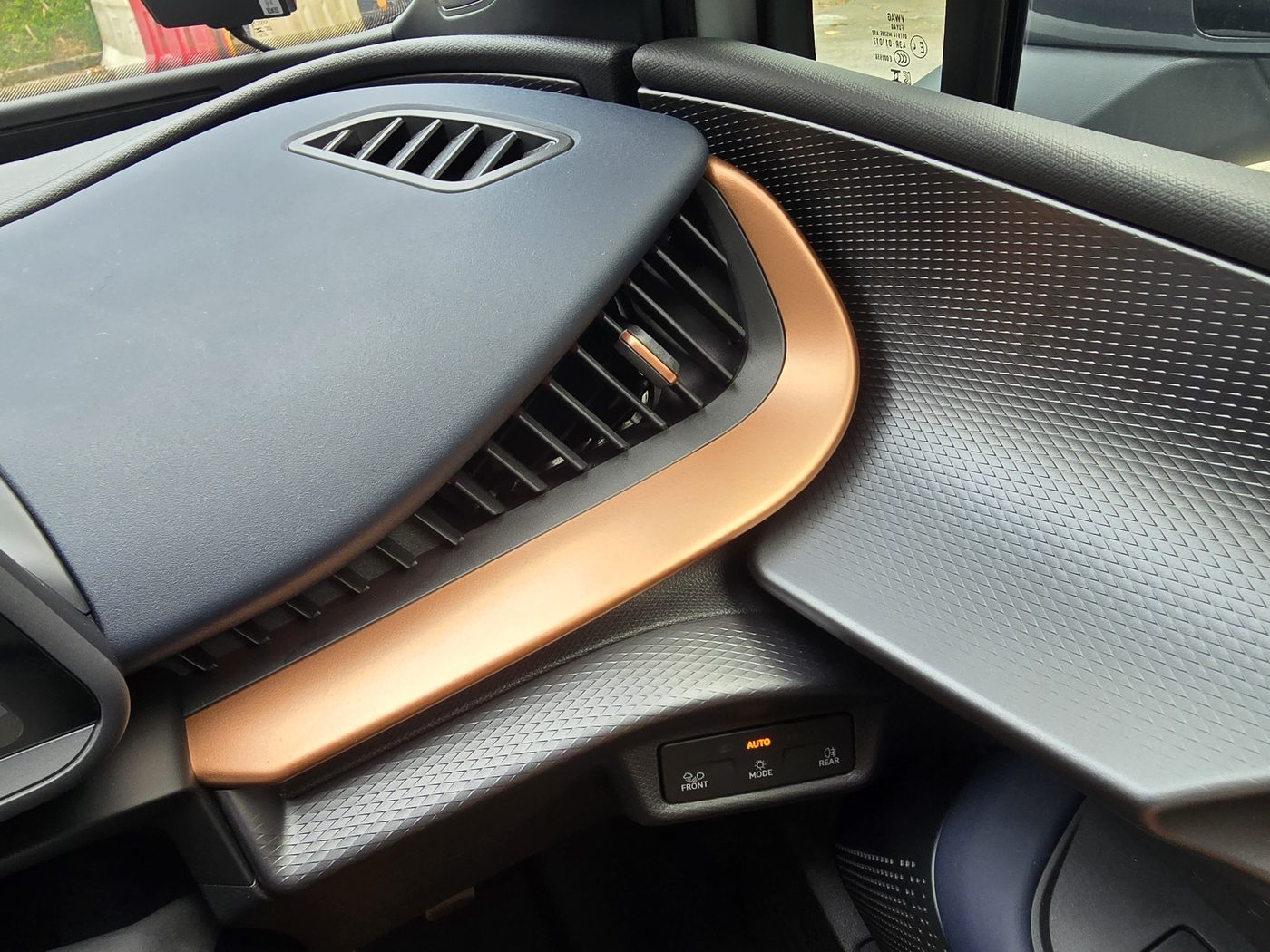 Cupra Tavascan dashboard air vent framed in copper trim