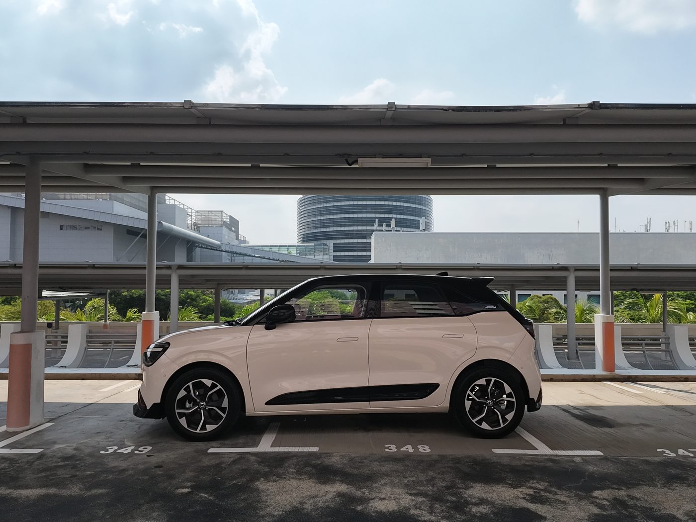 Side profile of the Dongfeng Box R in Twilight White with a black contrast roof, parked in a covered HDB car park