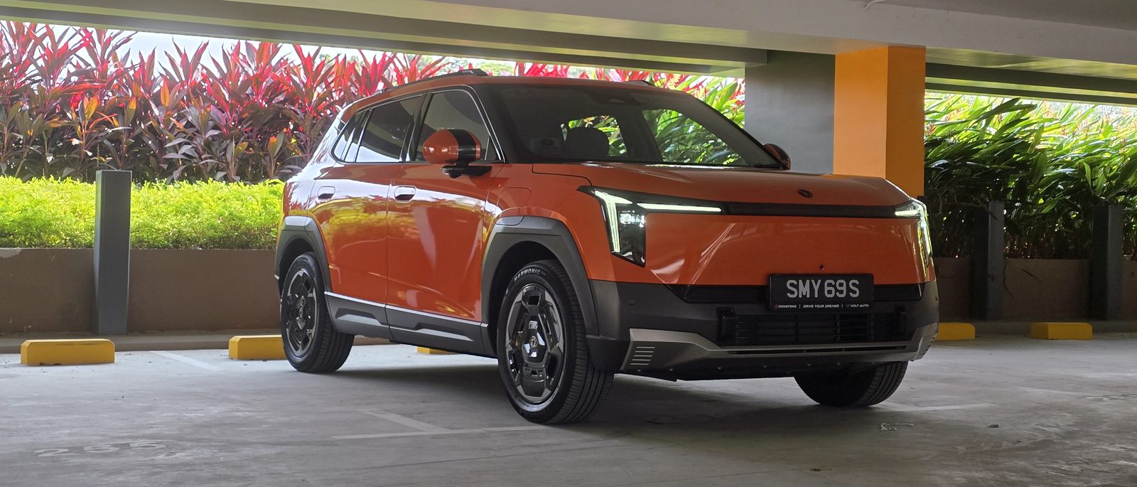 Dongfeng Vigo Essential in Canyon Orange, front three-quarter view in a Singapore multi-storey car park