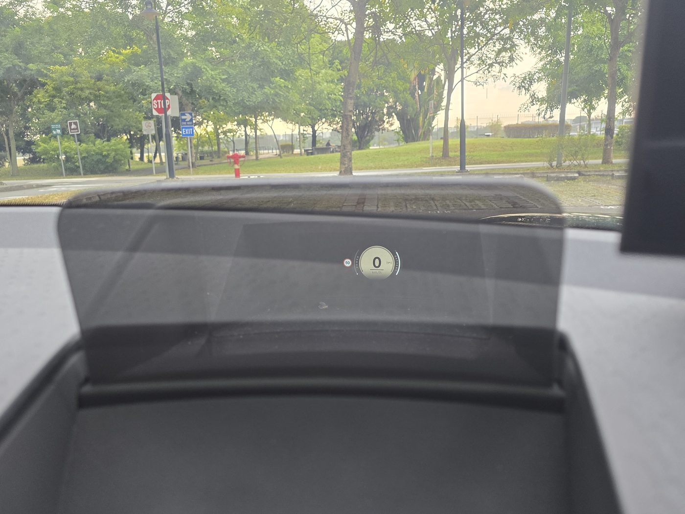 The MINI JCW Aceman E's flip-up head-up display combiner above the dashboard, showing the speed readout