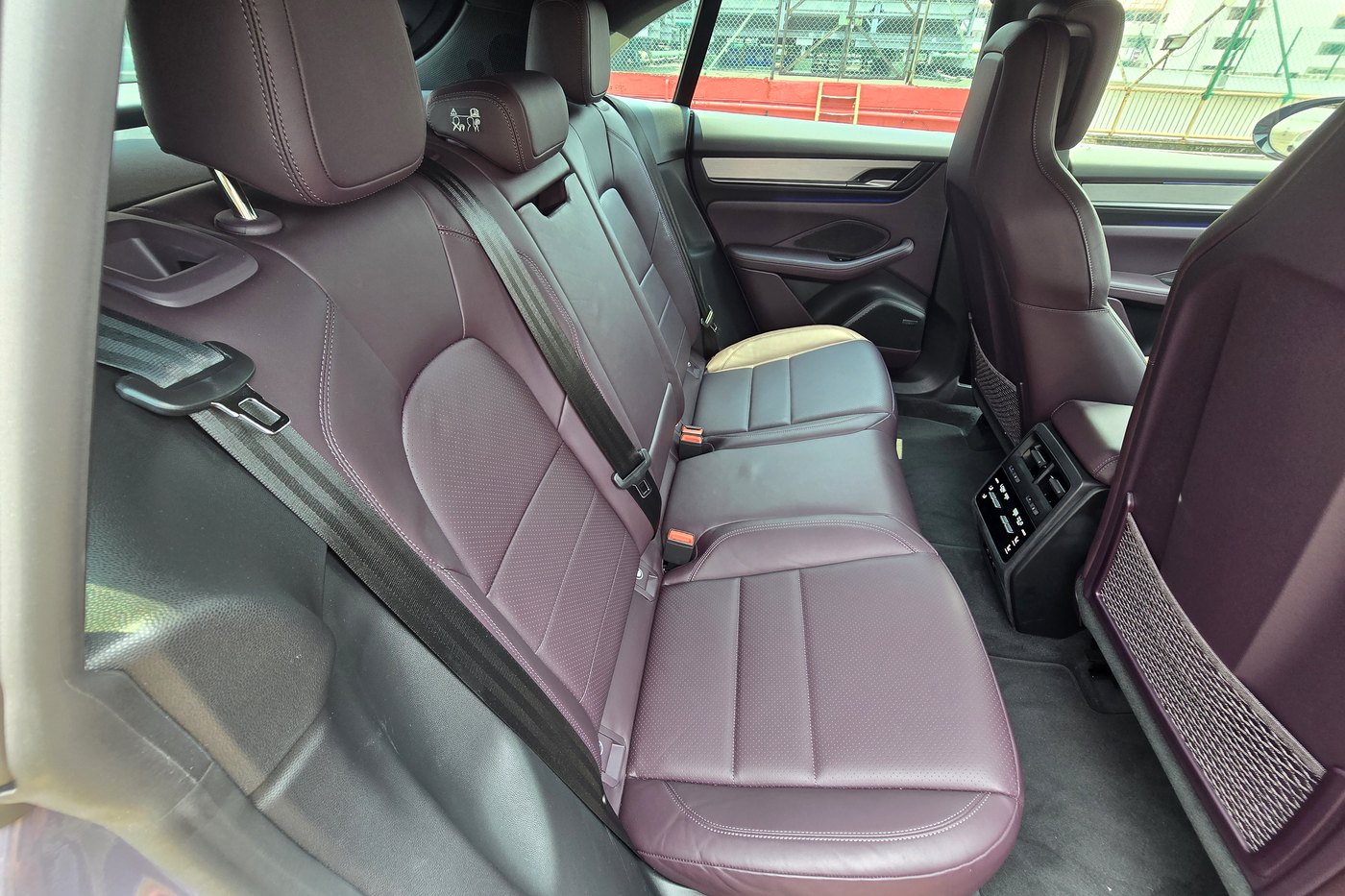 Porsche Macan Electric rear bench in Bramble leather with the front seat visible ahead of it