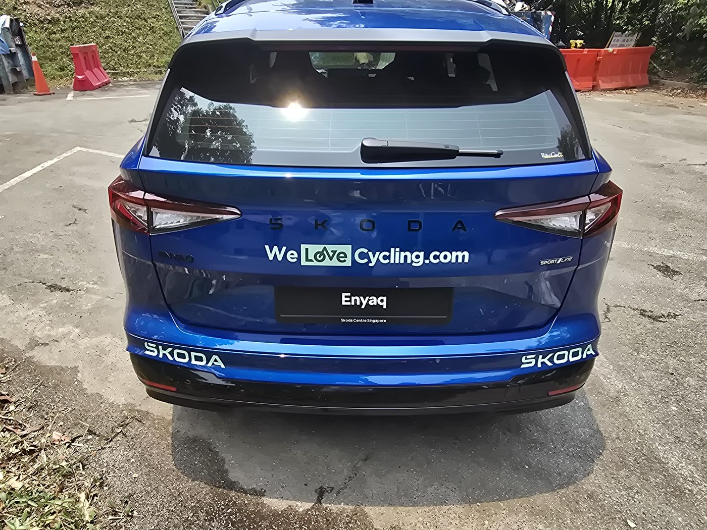 Rear of the Skoda Enyaq Sportline with Skoda lettering across the tailgate and the full-width light bar