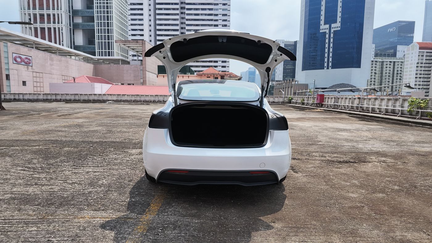Tesla Model 3 with the boot open on a rooftop carpark