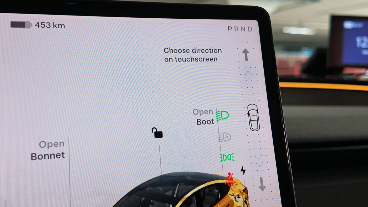 Tesla Model 3 touchscreen showing 453 km of range and the P R N D gear strip with the prompt Choose direction on touchscreen
