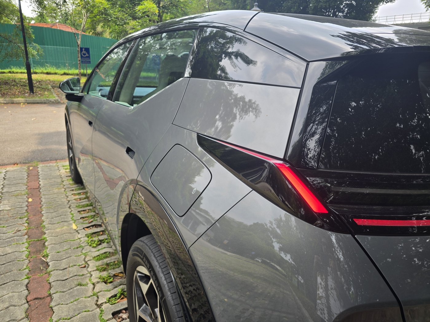 Close-up of the Zeekr X Urban rear flank, showing the flat body panel, hidden door handle and slot-shaped rear light