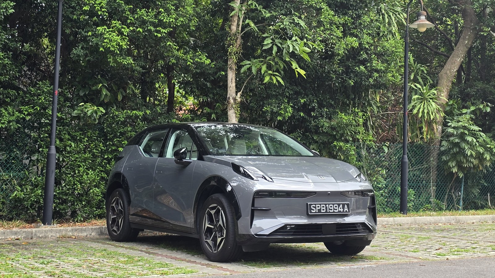 Grey Zeekr X Urban parked in front of trees in Singapore, front three-quarter view